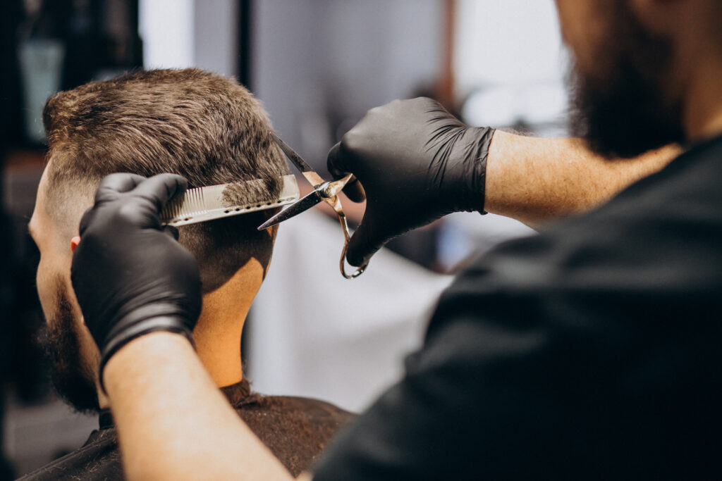 client doing hair cut at a barber shop salon