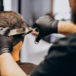 client doing hair cut at a barber shop salon